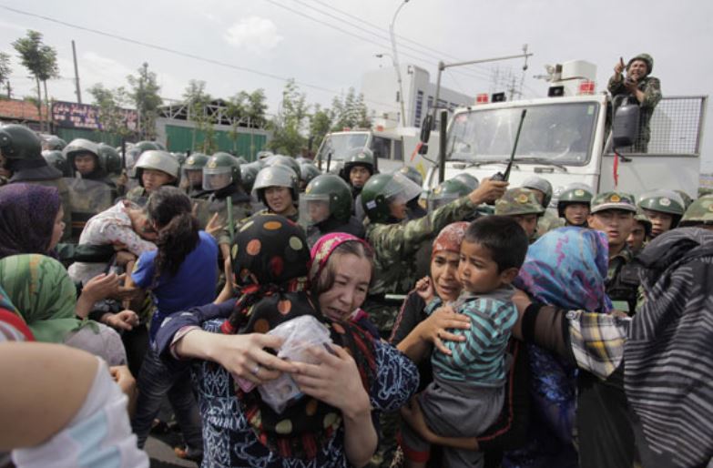 Police at a protest by Uyghurs in China's Xinjiang region in 2016. Wikimedia Commons